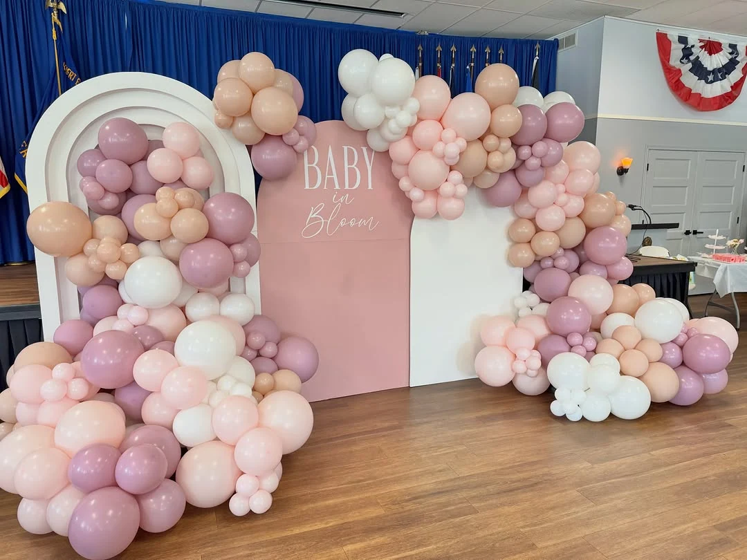 Pink Baby in Bloom baby shower backdrop with pastel balloons and white flowers